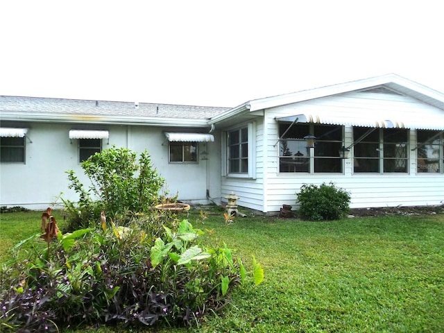 view of home's exterior with a yard