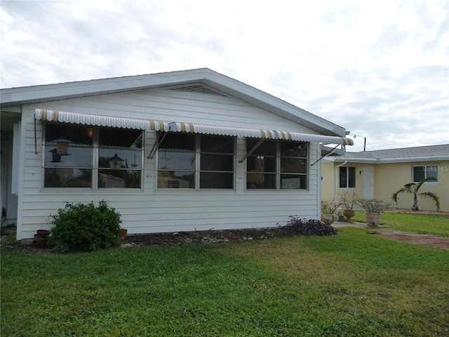 view of property exterior with a lawn