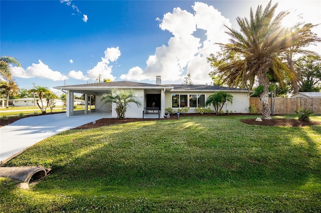 ranch-style house with a front yard and a carport