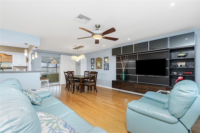 living room featuring light wood-type flooring and ceiling fan