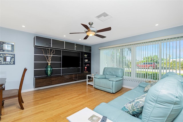 living room featuring hardwood / wood-style floors and ceiling fan