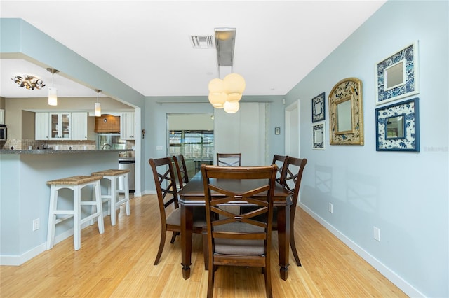 dining area with light wood-type flooring