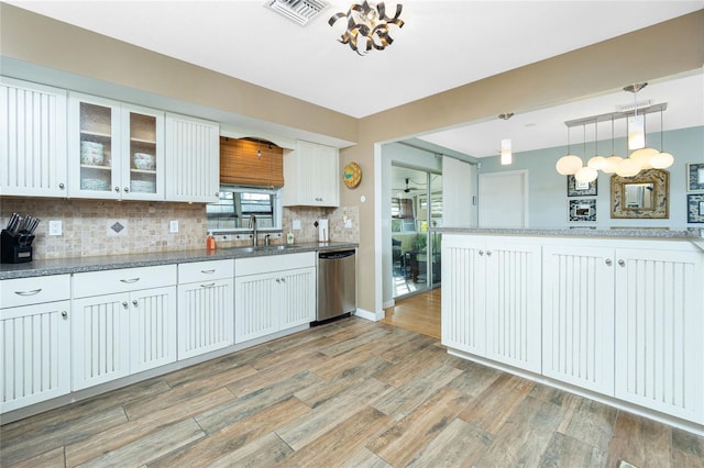 kitchen featuring dishwasher, white cabinets, light wood-type flooring, tasteful backsplash, and decorative light fixtures