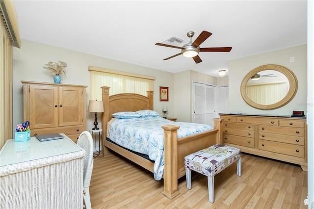 bedroom with ceiling fan, light wood-type flooring, and a closet