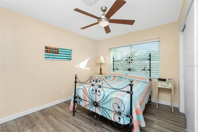 bedroom with hardwood / wood-style flooring and ceiling fan