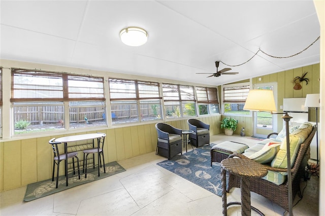 sunroom / solarium featuring ceiling fan