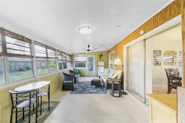 sunroom / solarium featuring ceiling fan