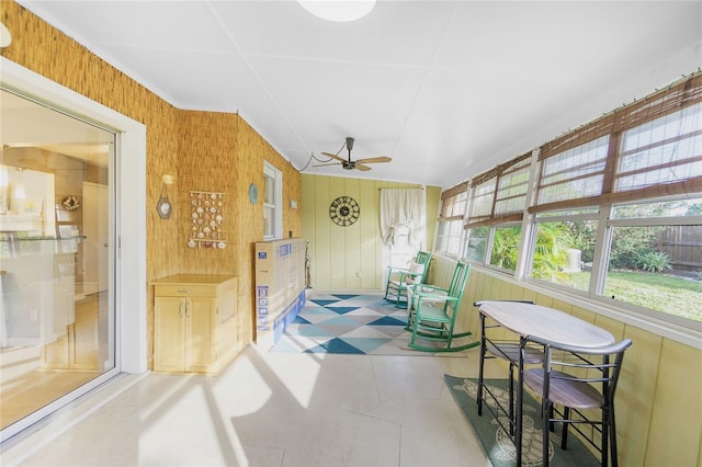 sunroom / solarium featuring ceiling fan