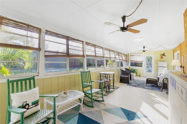 sunroom featuring ceiling fan and a healthy amount of sunlight