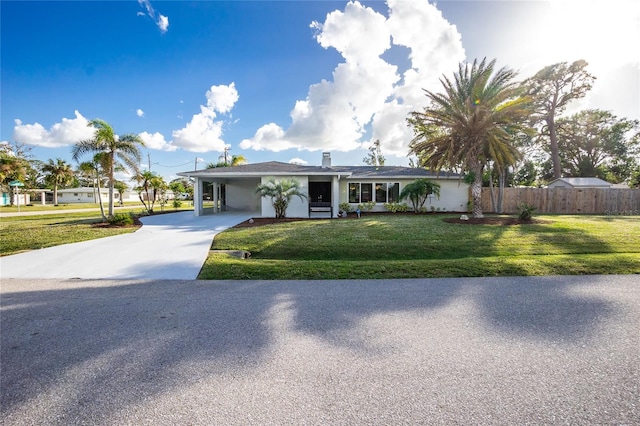 ranch-style house featuring a front yard and a carport