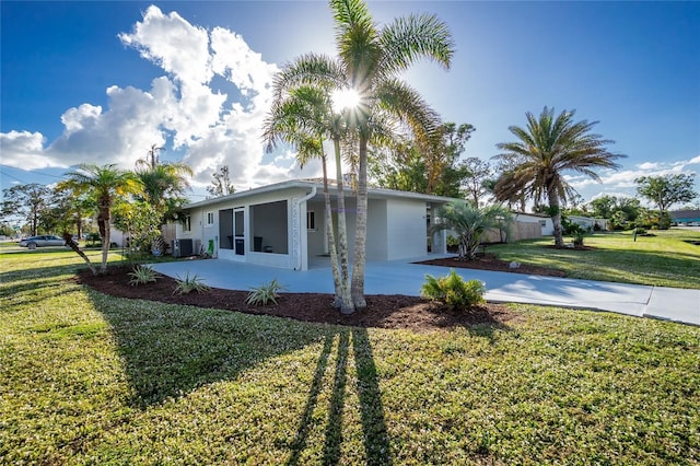 view of front of property with a front yard and a patio