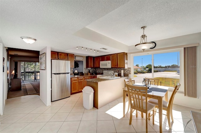 kitchen with sink, white appliances, plenty of natural light, and backsplash