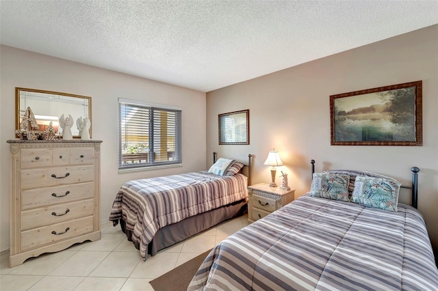 tiled bedroom featuring a textured ceiling