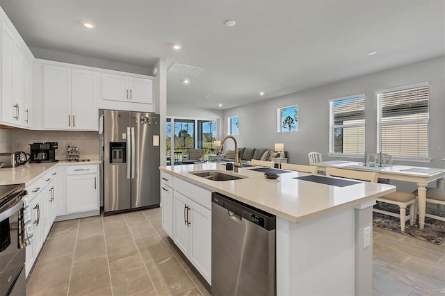 kitchen featuring sink, white cabinetry, and stainless steel appliances