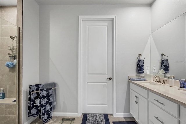 bathroom with vanity and a shower with shower door