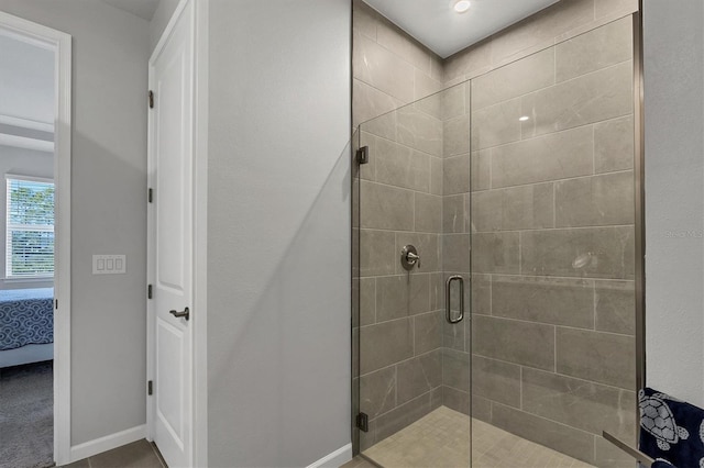 bathroom with tile patterned floors and walk in shower