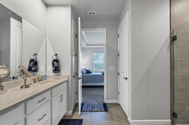 bathroom with vanity and a shower with door