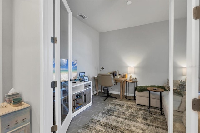 office space with dark tile patterned floors