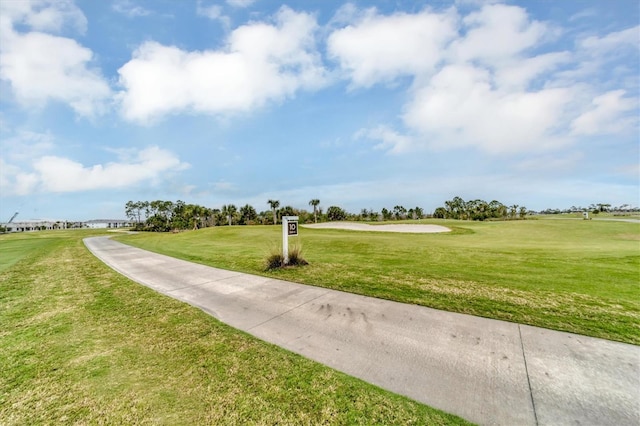 view of property's community with a lawn