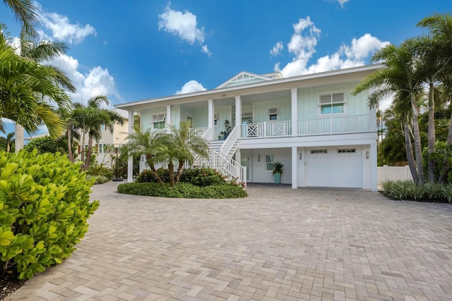 beach home featuring covered porch and a garage