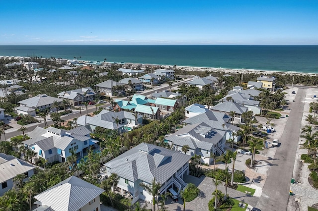 birds eye view of property with a beach view and a water view