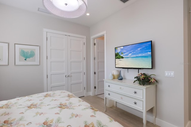 bedroom featuring light wood-type flooring and a closet