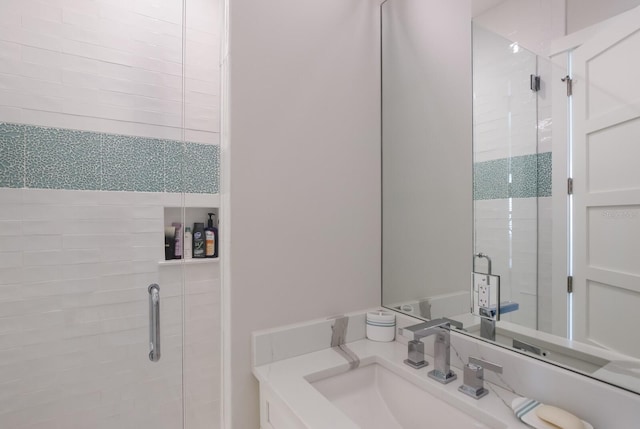 bathroom featuring an enclosed shower and vanity