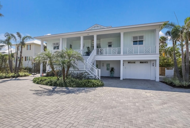 coastal home with covered porch and a garage