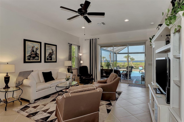 living room with light tile patterned floors and ceiling fan