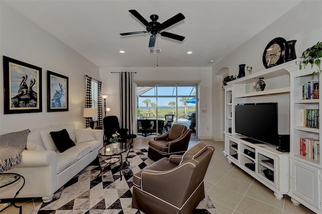 tiled living room with ceiling fan