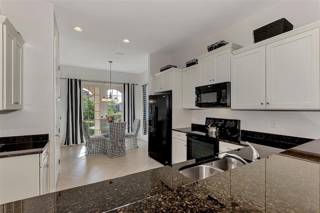 kitchen featuring white cabinetry, sink, a chandelier, decorative light fixtures, and black appliances