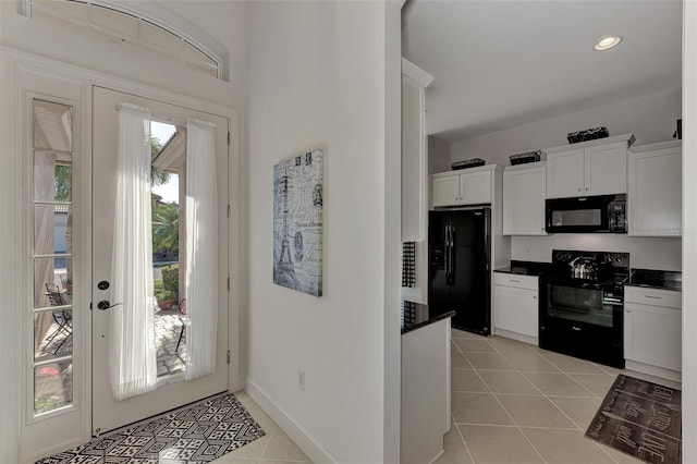 tiled foyer featuring a healthy amount of sunlight