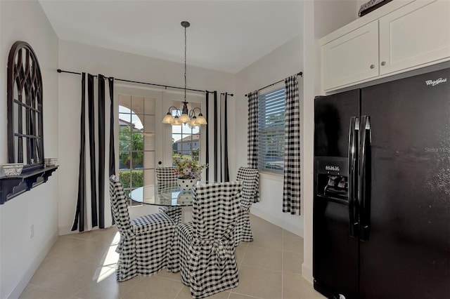 tiled dining room with plenty of natural light and a chandelier