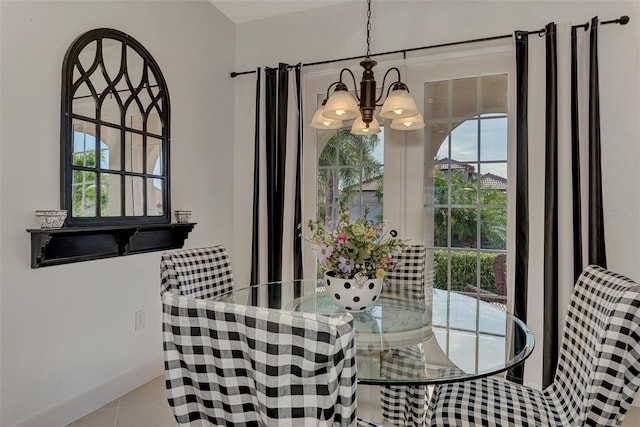 tiled dining area with a chandelier