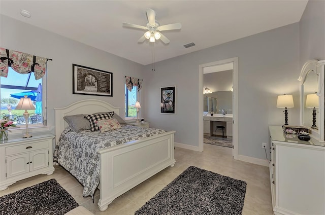 bedroom with ensuite bath, ceiling fan, and light tile patterned floors