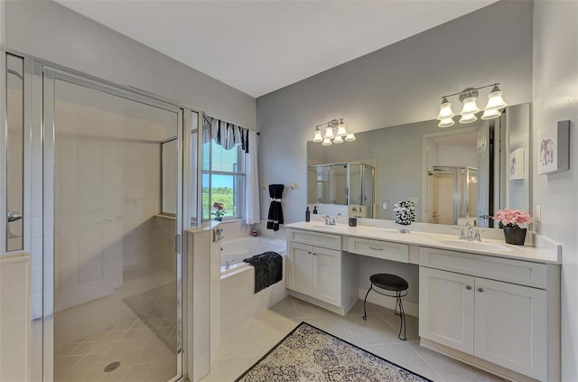 bathroom featuring plus walk in shower, vanity, and tile patterned flooring