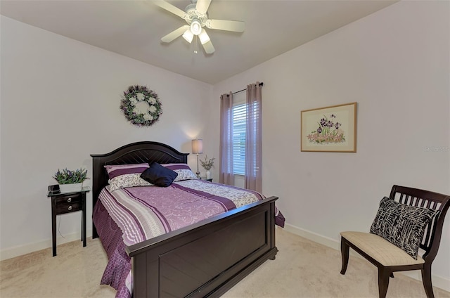 bedroom with ceiling fan and light carpet