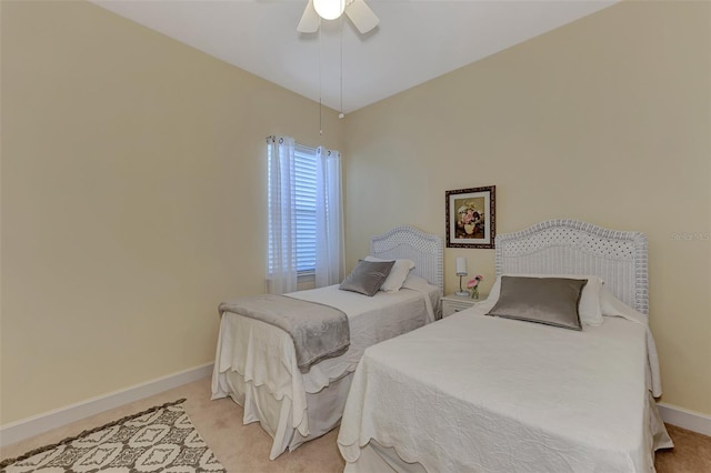 bedroom with ceiling fan and light carpet