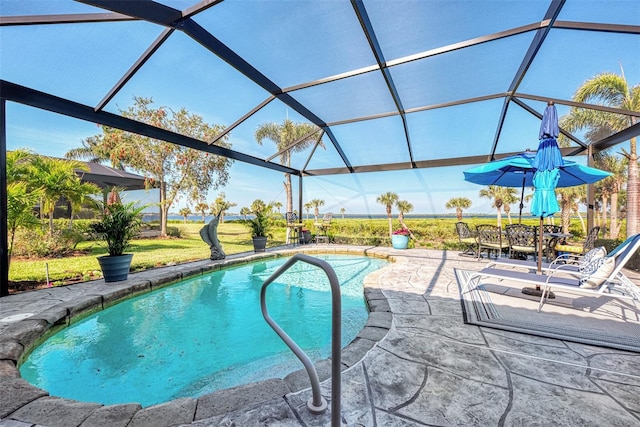 view of pool with a lanai, a patio area, and a yard