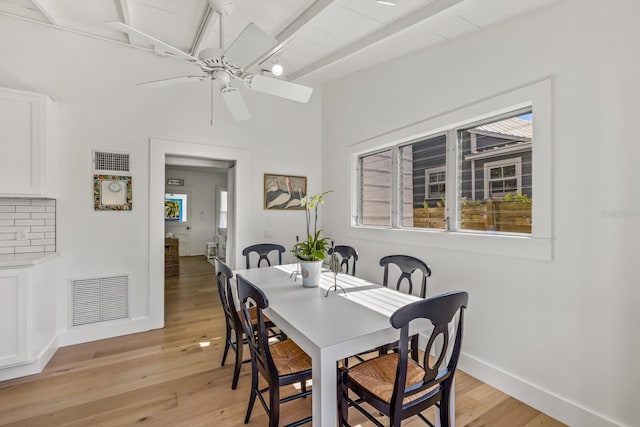 dining room with ceiling fan, beam ceiling, and light hardwood / wood-style floors