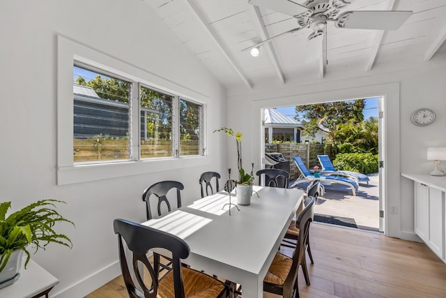 dining room featuring vaulted ceiling with beams, wooden ceiling, ceiling fan, and light hardwood / wood-style flooring