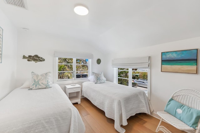 bedroom with lofted ceiling and hardwood / wood-style floors