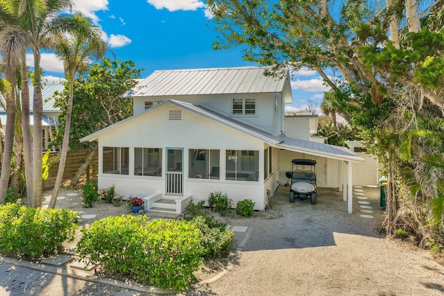 view of front of property featuring a carport and a sunroom