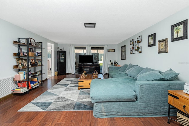 living room with dark hardwood / wood-style flooring