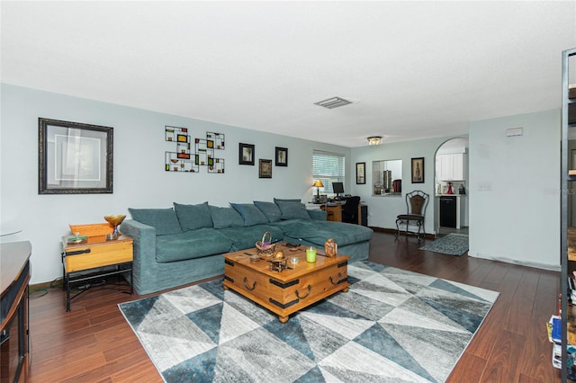 living room featuring dark wood-type flooring