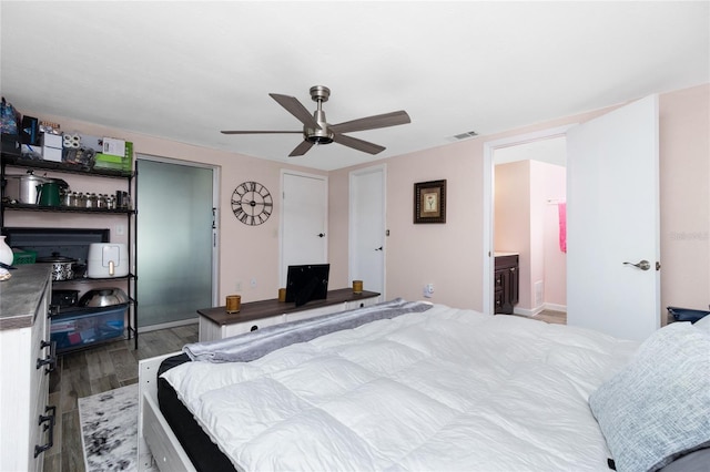 bedroom with ensuite bathroom, ceiling fan, and light hardwood / wood-style floors