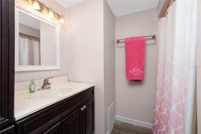 bathroom featuring vanity and wood-type flooring