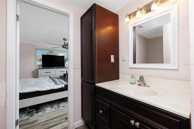 bathroom featuring hardwood / wood-style floors, vanity, and ceiling fan