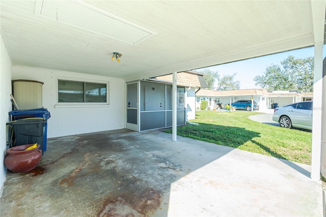 view of patio with a carport and a sunroom