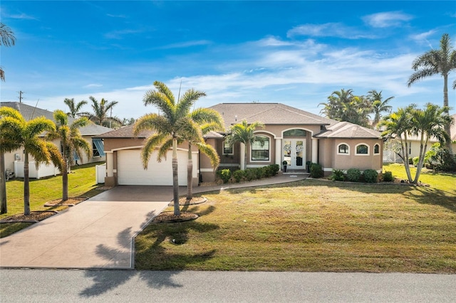 mediterranean / spanish home featuring french doors, a garage, and a front lawn